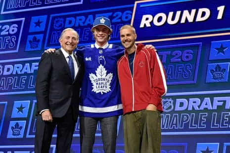 Gavin McKenna (center) stands with NHL commissioner Gary Bettman (left) and singer Justin Bieber (right) after being drafted first overall by the Toronto Maple Leafs.