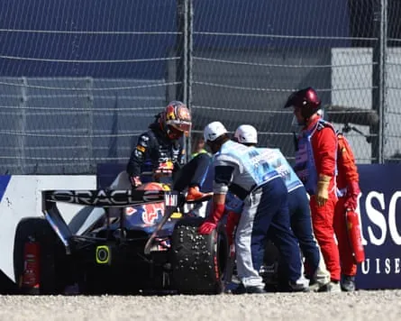 Marshals assist Max Verstappen after crashing his Red Bull