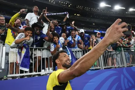 Vozinha poses for a selfie with fans after the game