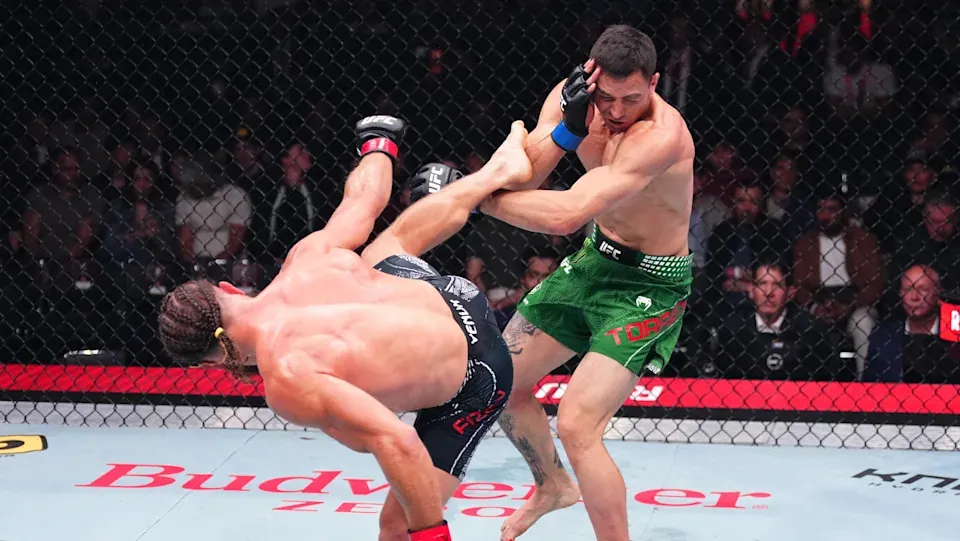 BAKU, AZERBAIJAN - JUNE 27: (L-R) Rafael Fiziev of Kazakstan drops Manuel Torres of Mexico with a kick in a lightweight fight during the UFC Fight Night event at National Gymnastics Arena on June 27, 2026 in Baku, Azerbaijan. (Photo by Jeff Bottari/Zuffa LLC)