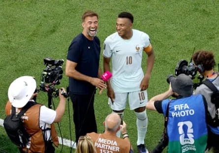 Jürgen Klopp, in his role as Magenta TV pundit, with Kylian Mbappé after France’s World Cup quarter-final against Morocco.