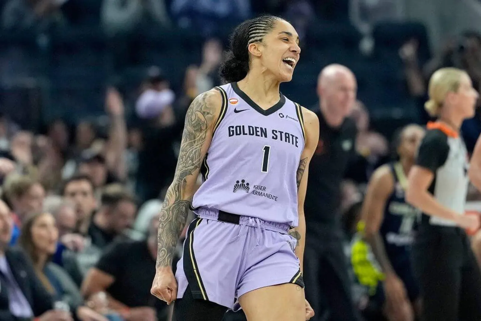 Gabby Williams, in a purple Valkyries jersey, celebrates making a 3-pointer during a June game against the Wings.