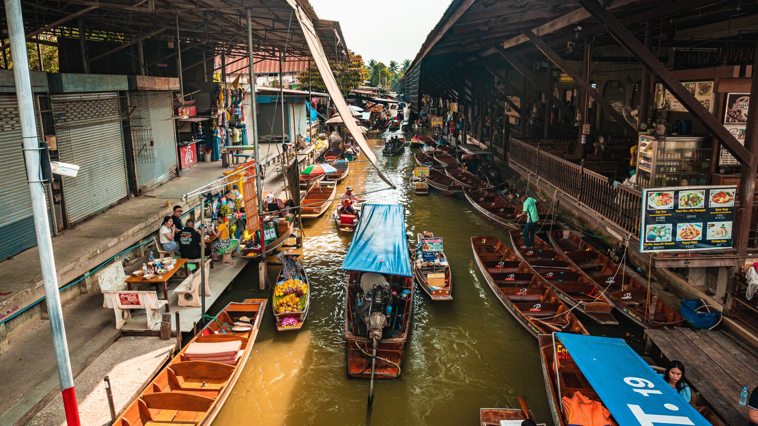 A canal in Bangkok with numerous local stores