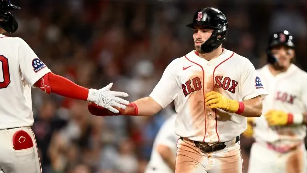 Caleb Durbin of the Boston Red Sox high fives Nick Sogard after scoring a run against the Chicago White Sox during the sixth inning at Fenway Park on August 4, 2026 in Boston. (Photo by Brian Fluharty/Getty Images)
