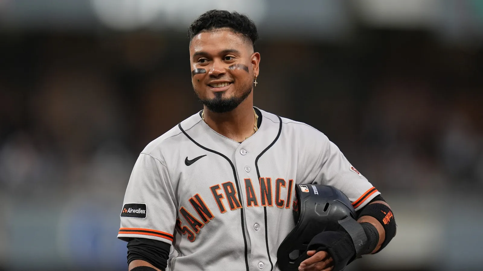 San Francisco Giants' Luis Arraez jokes with players in the San Diego Padres dugout during the fourth inning of a baseball game Thursday, July 30, 2026, in San Diego.