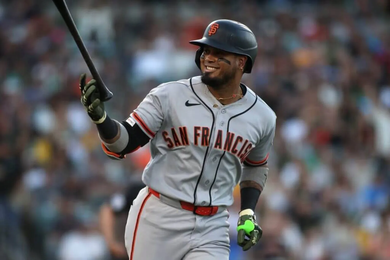 Luis Arraez of the San Francisco Giants reacts towards his dugout after hitting a solo home run during the fourth inning against the Athletics at Sutter Health Park.