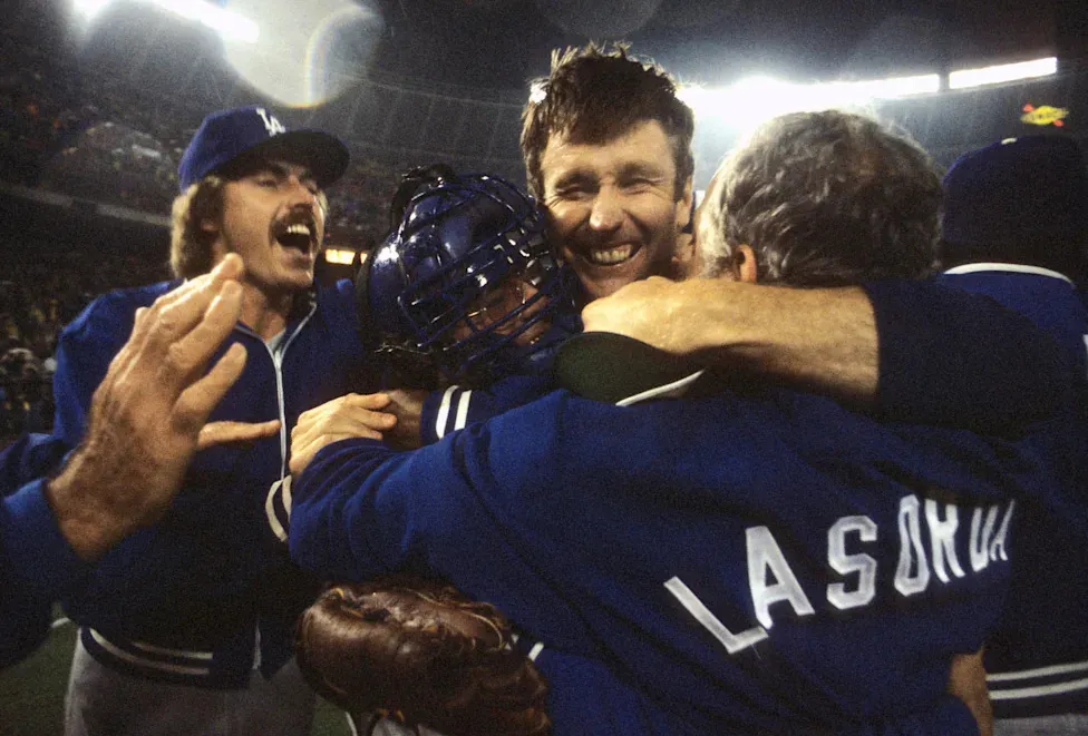 Baseball: NLCS Playoffs: Los Angeles Dodgers Tommy John (25) victorious, hugging mananger Tom Lasorda (2) after winning Game 4 and series vs Philadelphia Phillies. Philadelphia, PA 10/8/1977 CREDIT: Walter Iooss Jr. (Photo by Walter Iooss Jr. /Sports Illustrated via Getty Images) (Set Number: X21820 TK2 R4 F19 )