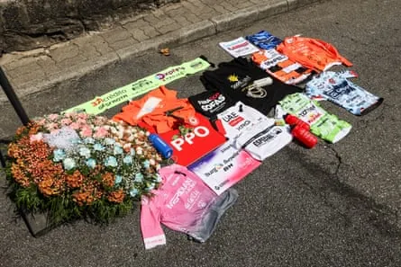 Cycling jerseys and flowers laid in a tribute.